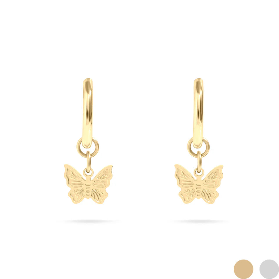 A pair of gold huggie hoop earrings with butterfly charms hanging from them.